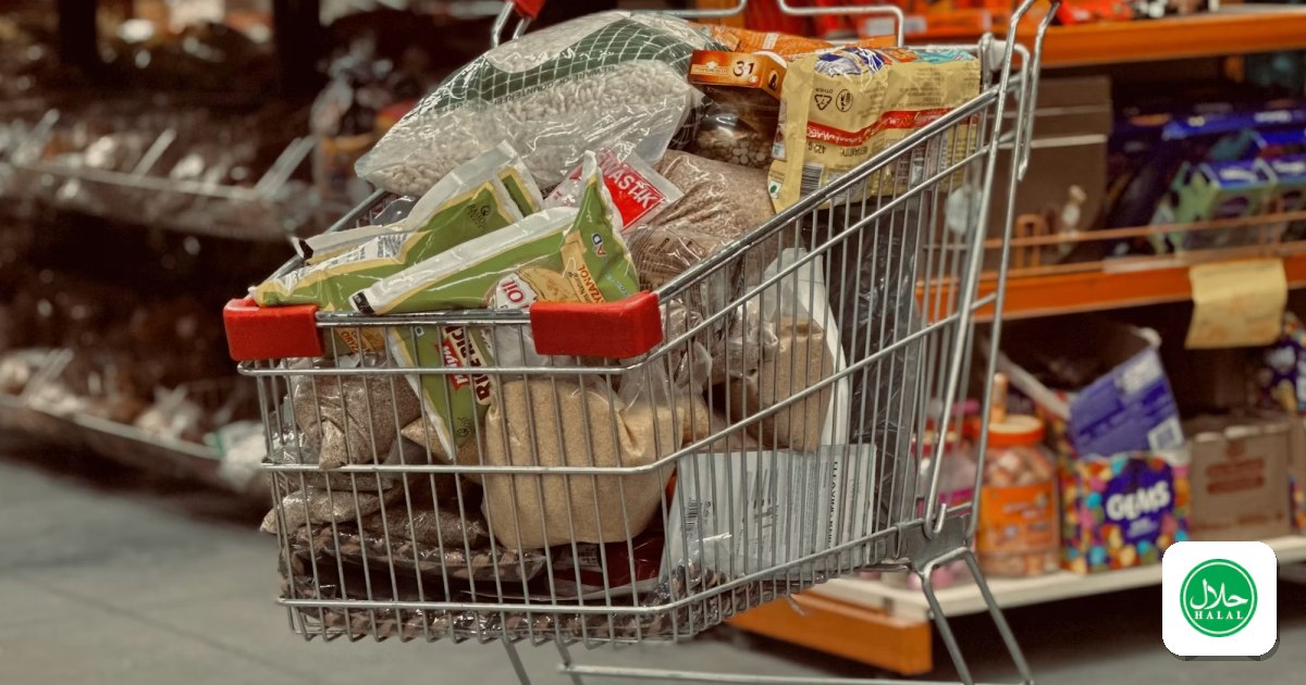 A shopping cart full of groceries in a grocery store aisle