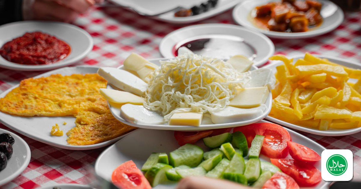 A table laden with a diverse Turkish breakfast spread of cheeses, olives, eggs, and small plates