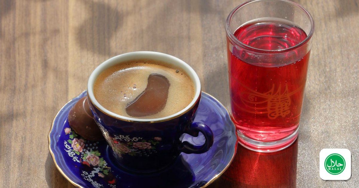 A cup of coffee and a glass of tea on a cafe table