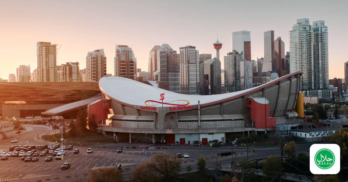 Downtown Calgary skyline behind the Scotiabank Saddledome at sunset