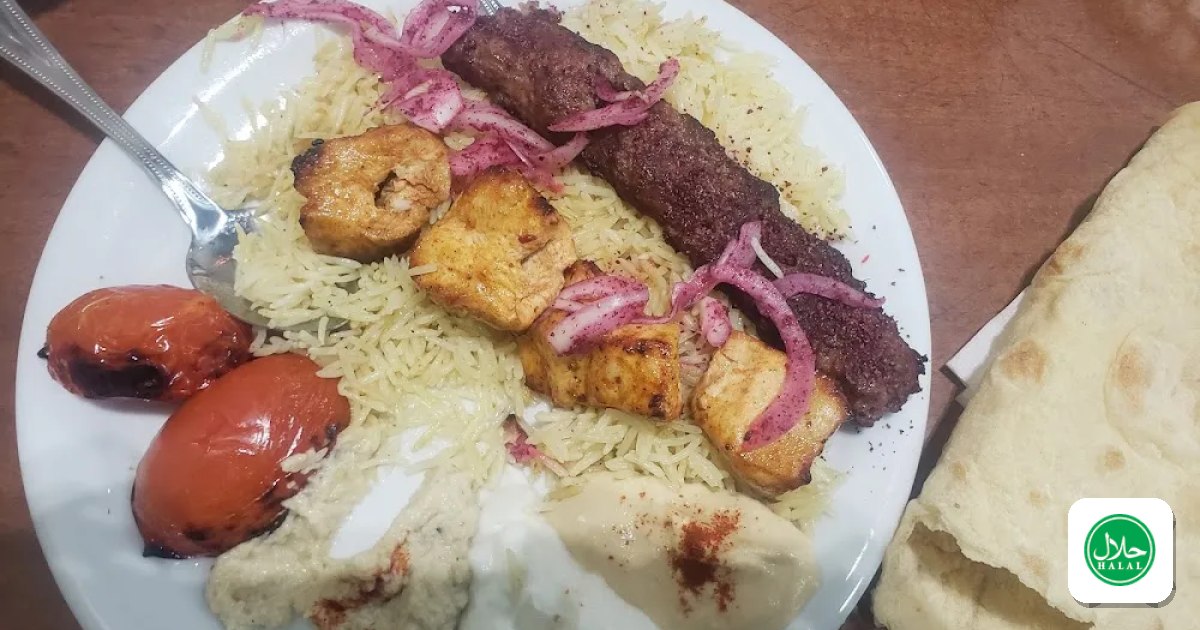 Catering trays of rice and grilled meat laid out for an event