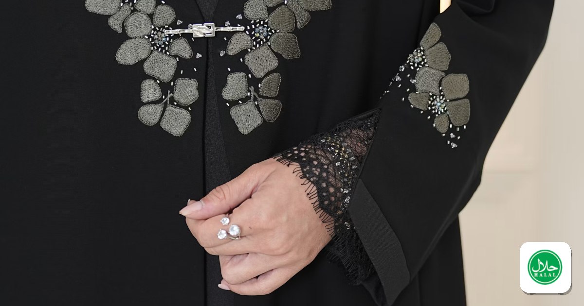 An elegant black abaya with detailed floral embroidery and lace cuffs