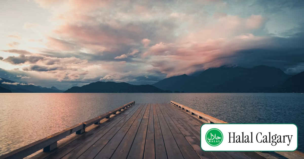 A wooden dock on a calm prairie lake in summer