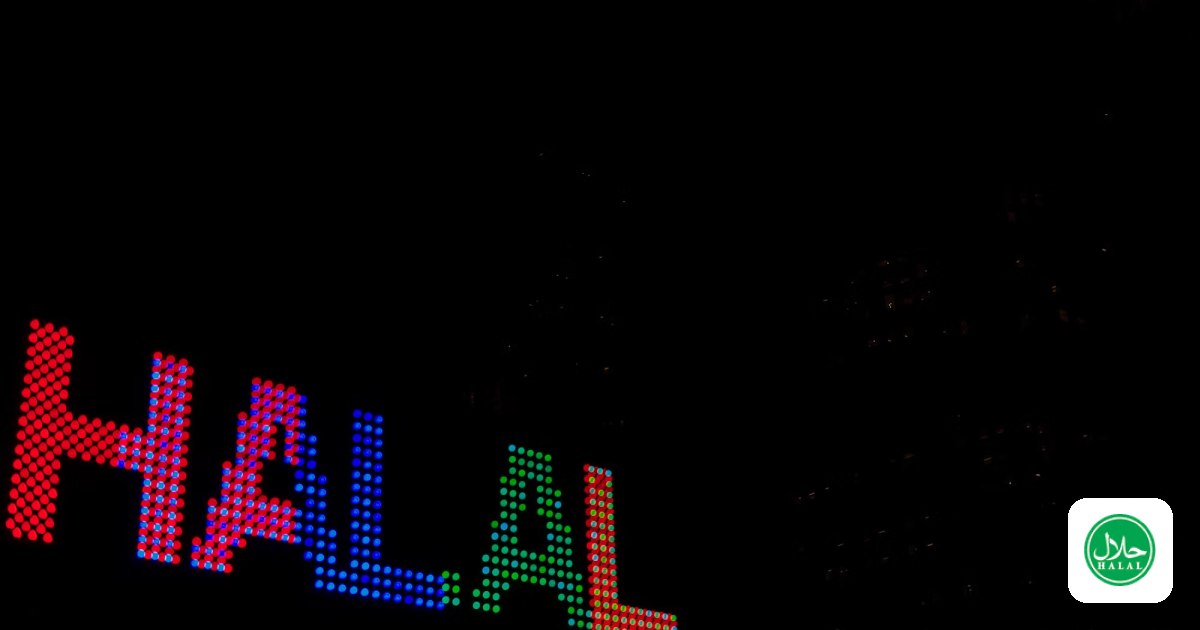 An illuminated halal sign at night