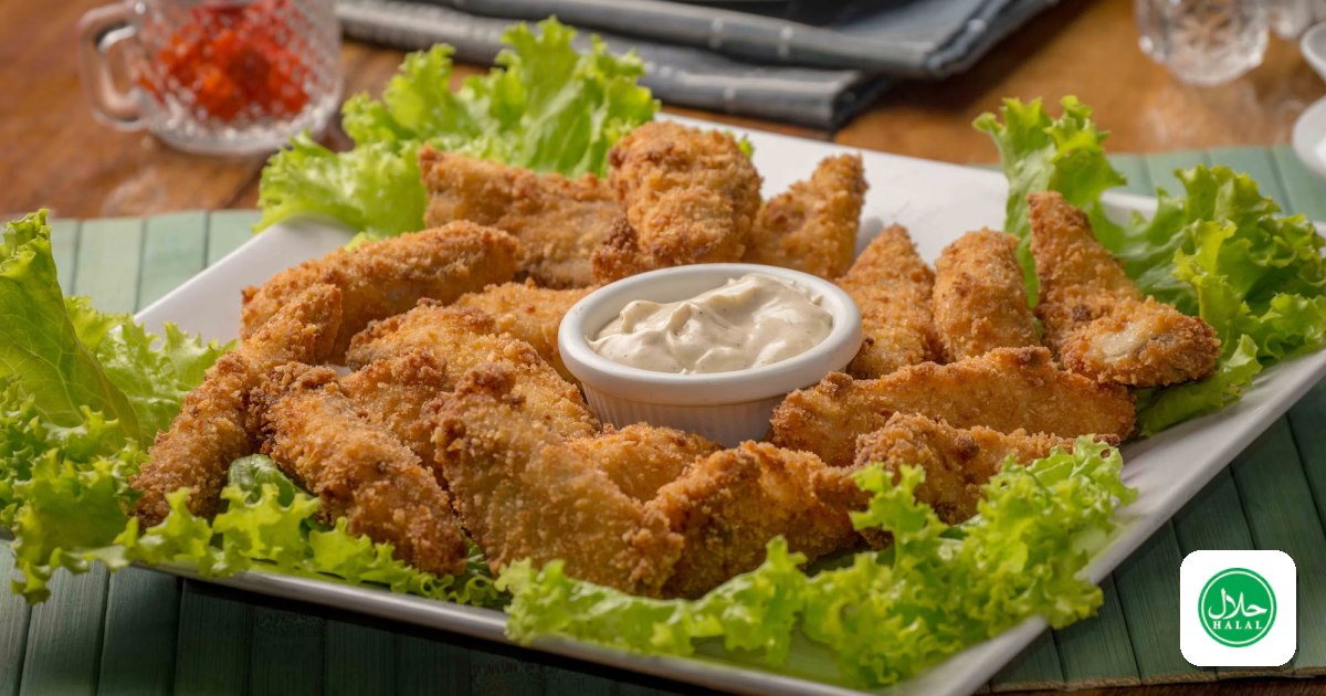 Breaded fried chicken tenders plated with a dipping sauce
