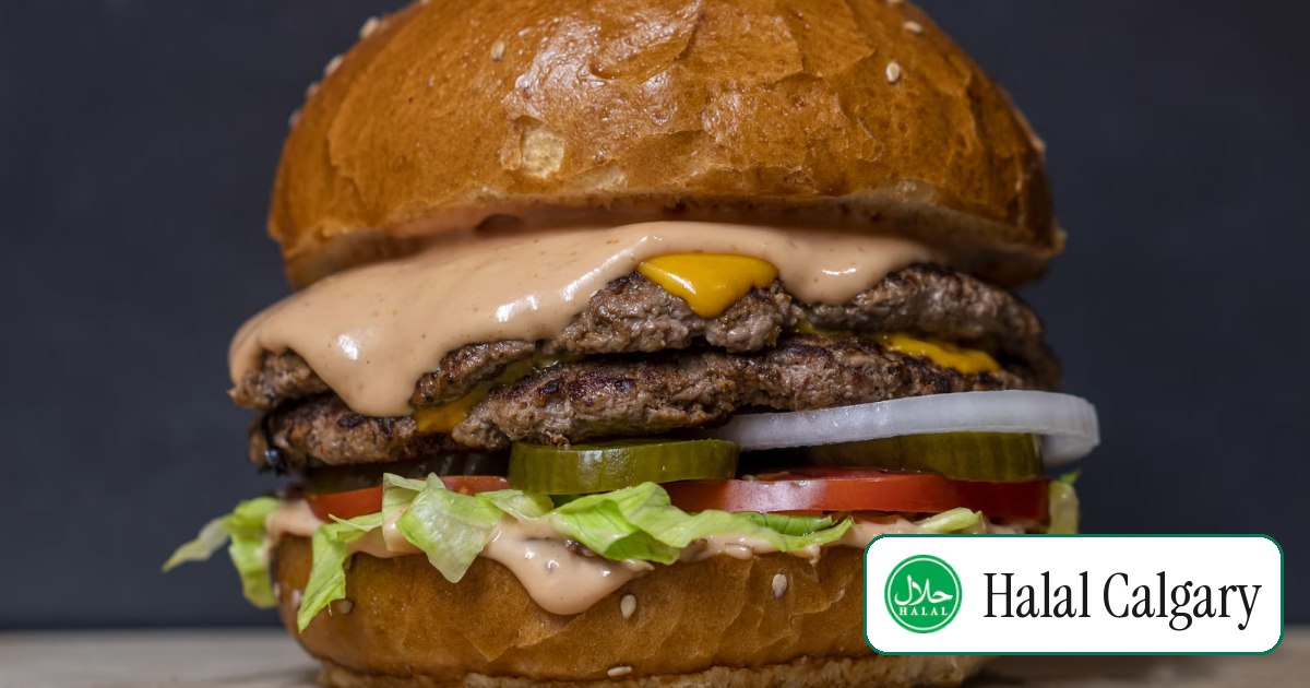 A double cheeseburger with lettuce, tomato and onion on a toasted bun