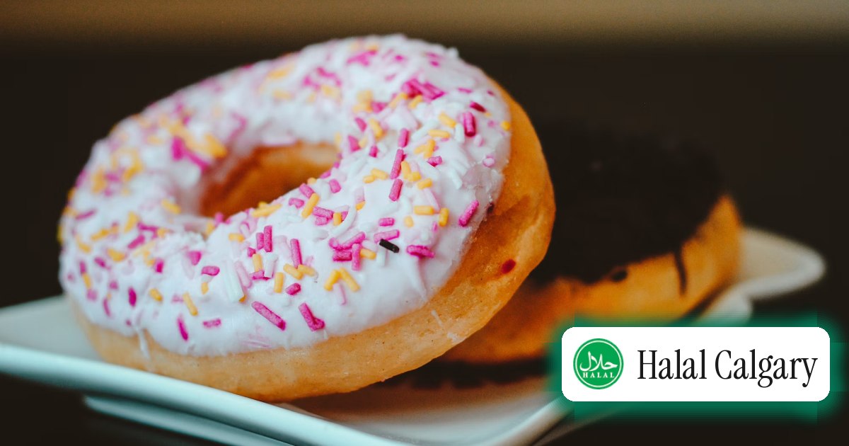 Sprinkled and chocolate-dipped donuts on a plate