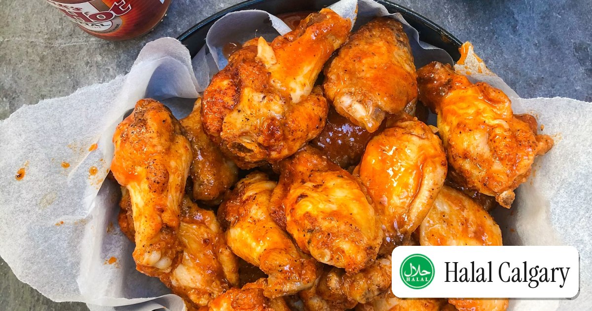 Glazed chicken wings stacked on a plate