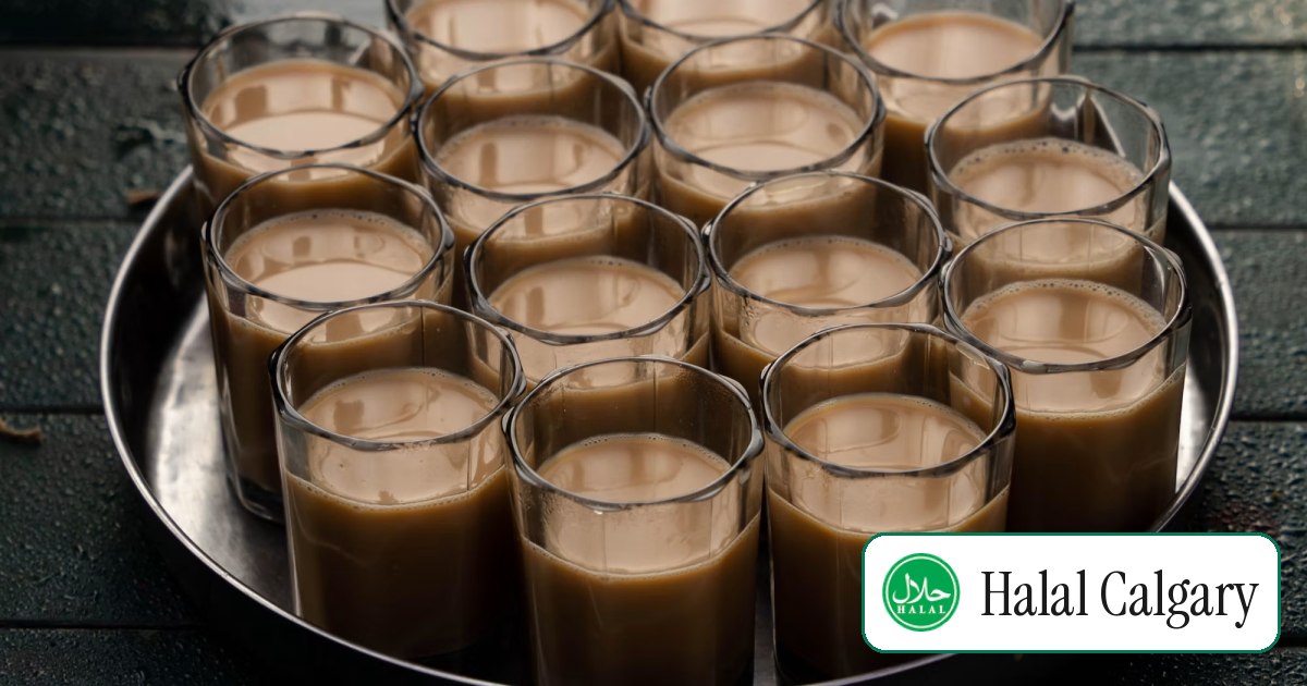 A steel tray crowded with glasses of milky karak chai