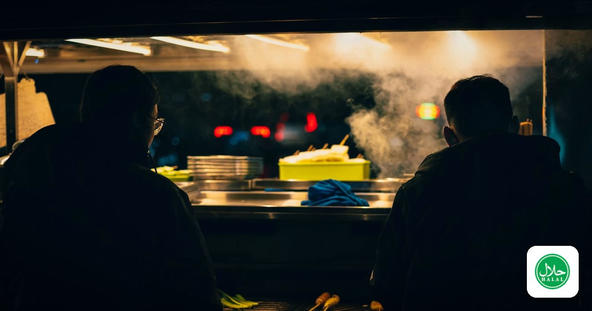 Two cooks working a steamy kitchen line late at night