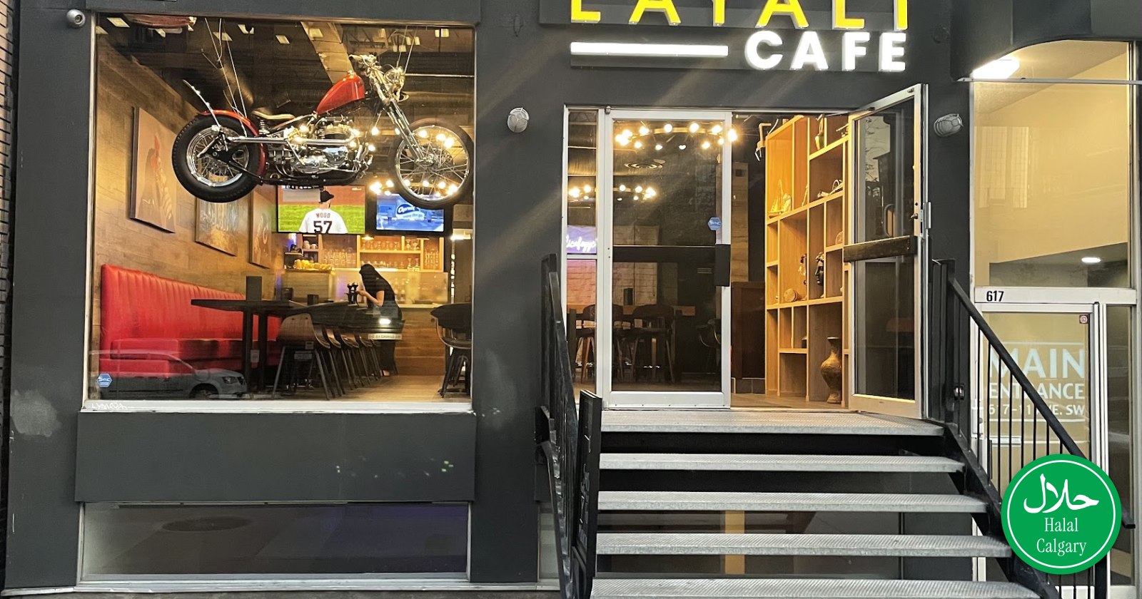 The lit Layali Cafe sign above its 11 Avenue SW entrance at night