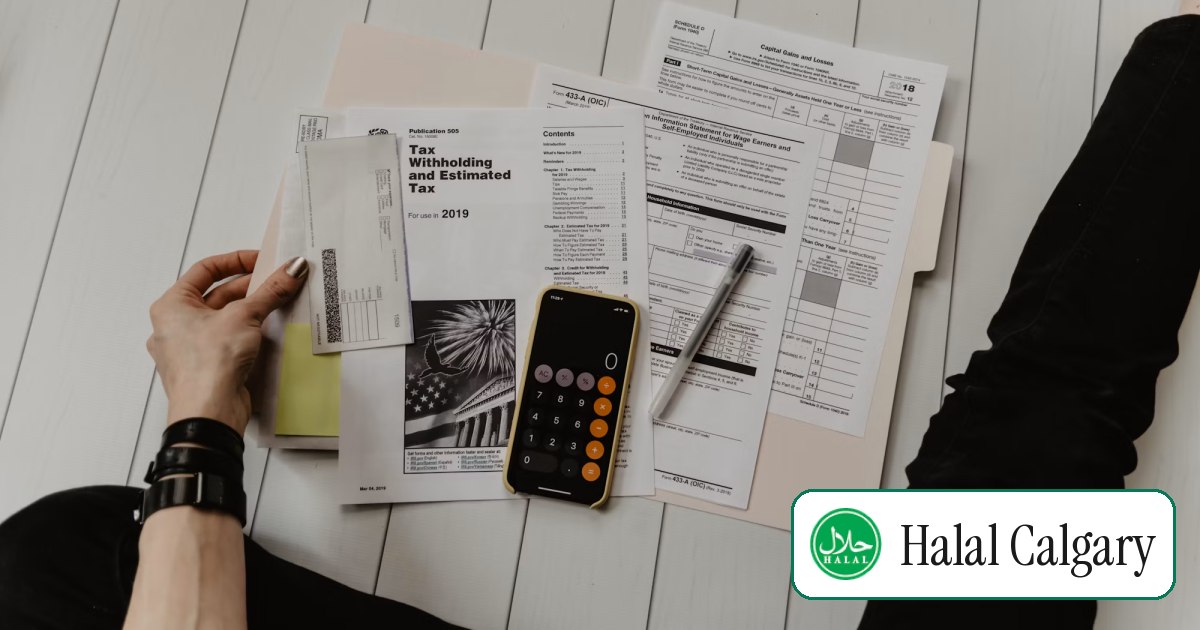 A calculator and pen on top of spread-out financial paperwork